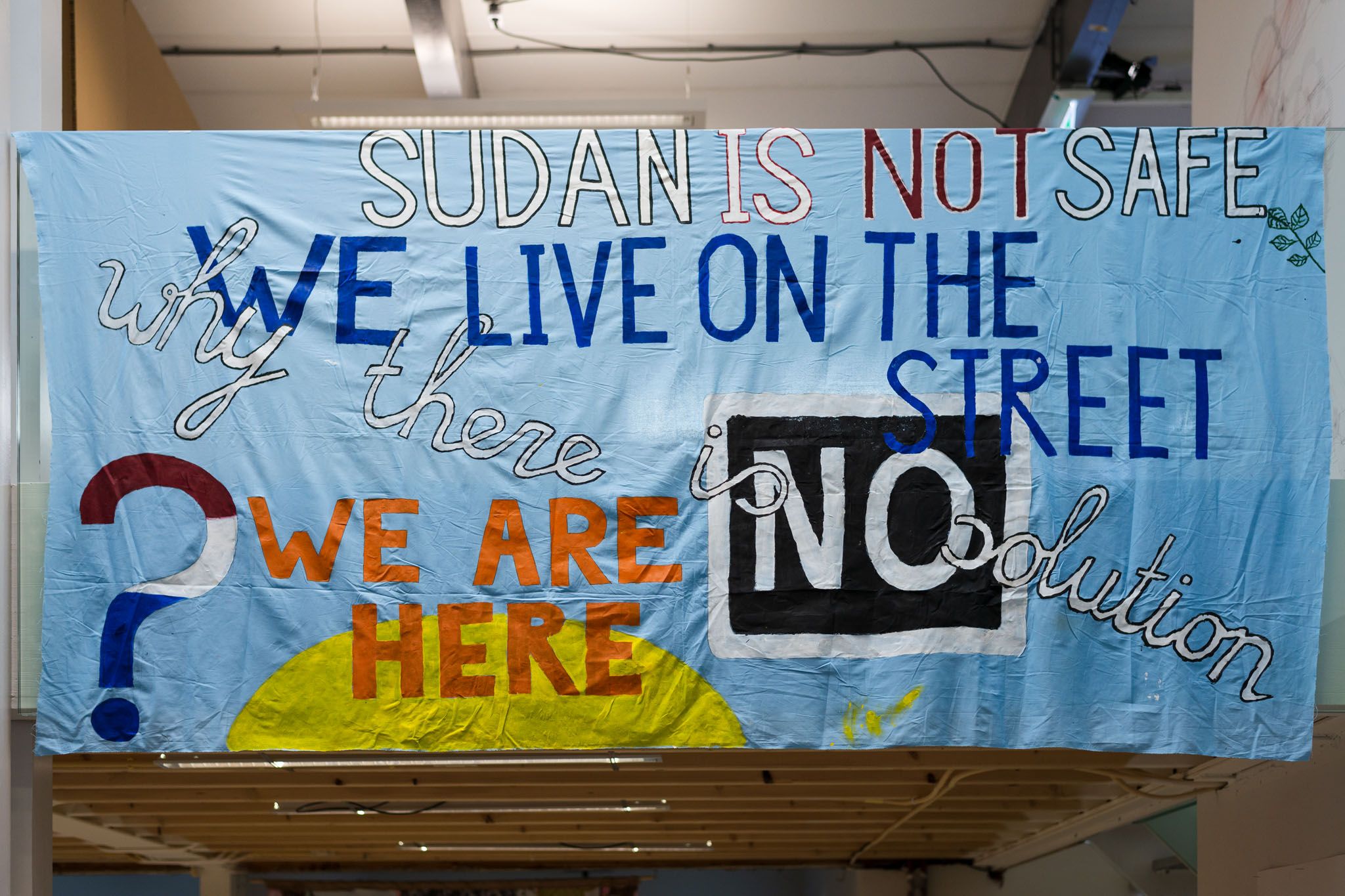 Banner by We Are Here collective, installed at Trainings for the Not-Yet: Decommodifying Housing, BAK basis voor actuele kunst, Utrecht. © Photo: Tom Janssen